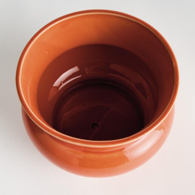 In a traditional English silhouette, this pot has a regal charm. Finished with a rich, orange reactive glaze, it is a...