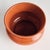 In a traditional English silhouette, this pot has a regal charm. Finished with a rich, orange reactive glaze, it is a...