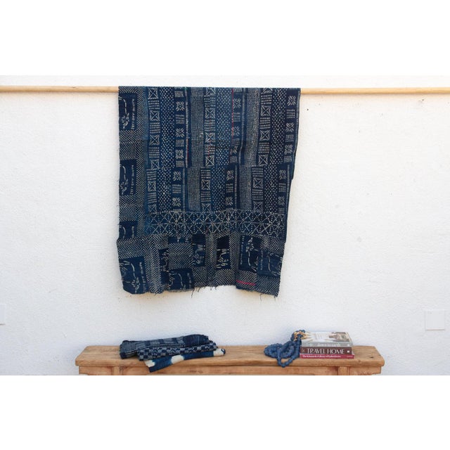 A masterwork of Malian textile heritage featuring deep indigo saturation and symbolic geometric motifs. Originating from...