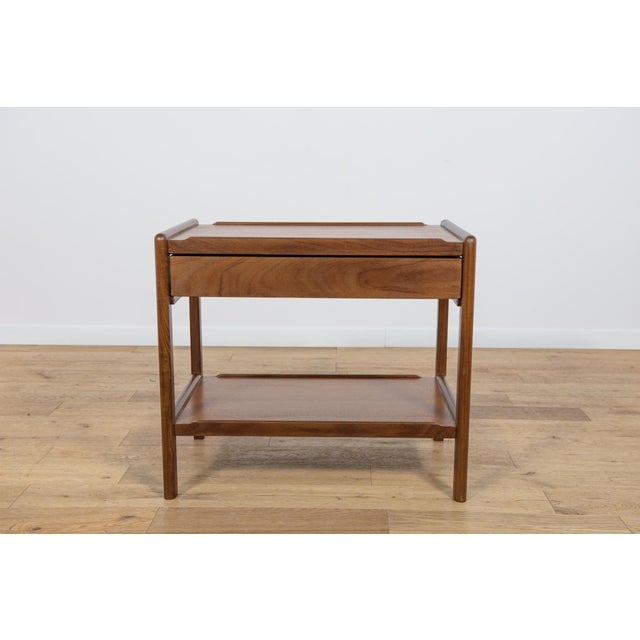 Console made in Denmark in the 1970s. Made of teak wood, with a shelf in the lower part and a drawer in the upper part. It...