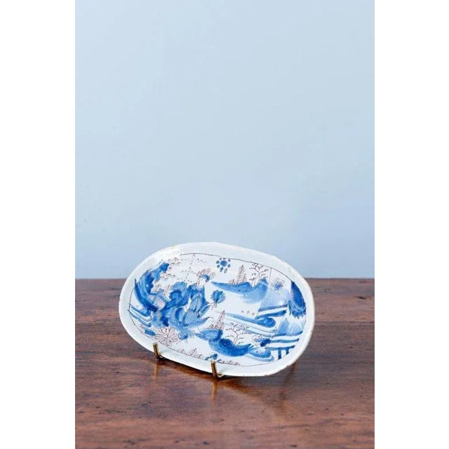 A small, elegant late 17th-century French faience tray from Nevers, delicately painted in blue and white with manganese...