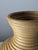 This large floor vase is constructed from continuously coiled natural rattan reeds, forming an amphora-inspired...