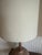 Tan and Ivory ceramic lamp with a lava glaze texture and stipe pattern. Accented by a walnut base and neck and the...
