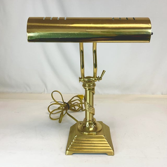 This is a vintage Art Deco style Piano Desk Lamp from the 1970s. It features a pyramid base and a swirled accent on the...