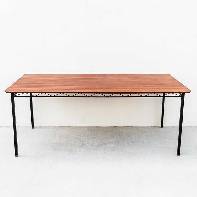 A newly refinished South African mid-century modern dining table in sapele mahogany and welded steel, made by D.S. Vorster...