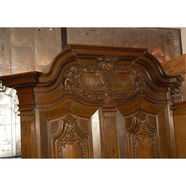 This monumental cabinet has a most decorative central feature with carving of: figures, thistles, fruit, leaves, scrolls,...