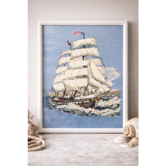 A beautifully executed vintage hand-stitched nautical artwork, featuring a classic tall ship navigating textured ocean...