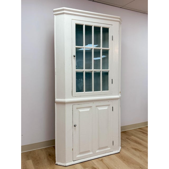 This antique corner cabinet showcases a genuinely charming glass paneled door, offering an ideal display space for china,...