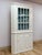 This antique corner cabinet showcases a genuinely charming glass paneled door, offering an ideal display space for china,...