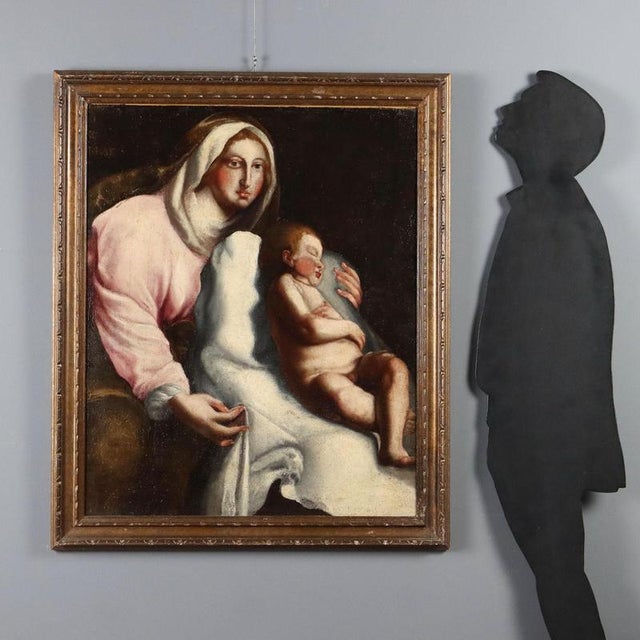 Oil on canvas. Detail of this Madonna holding her Child, who is lying on a pillow and fast asleep. Mary looks at the...