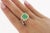 GRS Certified 2.66 Carat Minor Oil Colombian Emerald. Set with a gorgeous round cut diamond halo and diamond set split...