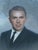 A striking mid‑century oil portrait featuring a distinguished gentleman painted in a classic realist style. This vintage...
