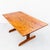 Restored trestle base dining table in solid shedua wood by Gerald McCabe, made in Southern California c. 1970s. Shedua,...