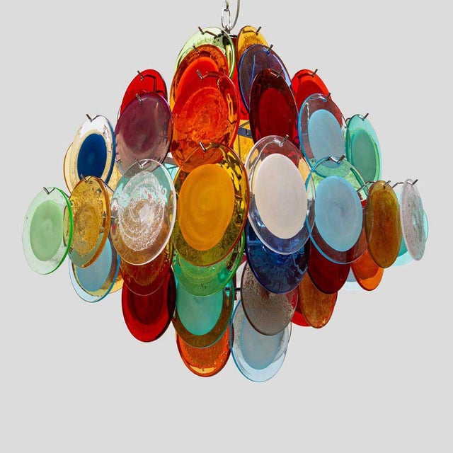 A unique chandelier composed of multicoloured Vistosi glass discs in blue, orange, red, yellow, white, green, Campari,...