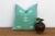 A framed border and two stacked bowtie-diamond medallions anchor the center of this handcrafted Moroccan cactus silk...