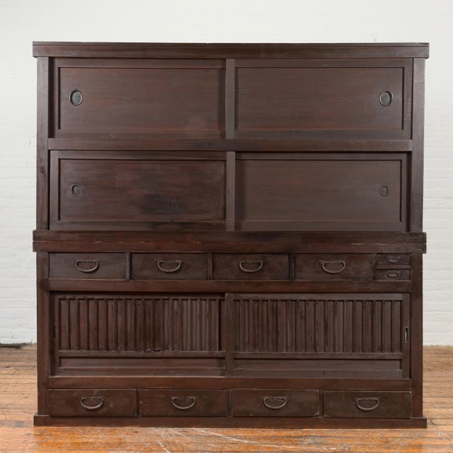 A Japanese Taisho period kiri wood clothing Mizuya Dansu kitchen cabinet from the early 20th century, with sliding doors...