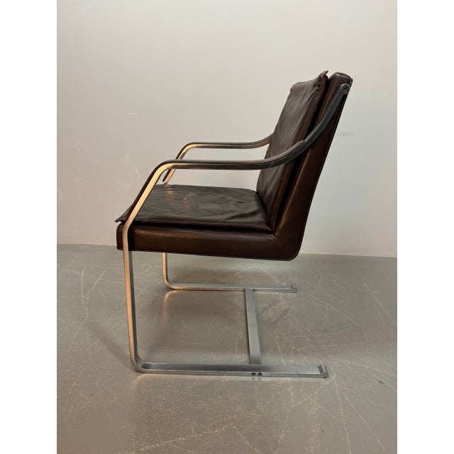 Set of four Art Collection sled chairs designed by Rudolf Glatzel for Walter Knoll. Upholstered in a chocolate brown...