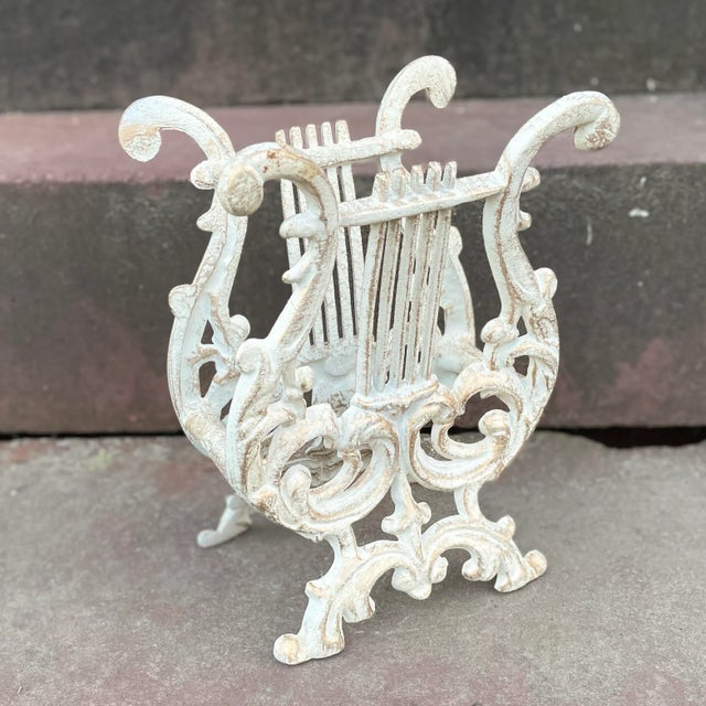 Vintage MCM lyre or harp shaped rack. Finished with an almost iridescent in appearance white shade with gold accents and...