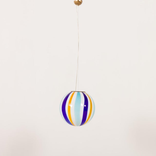 Striking Italian Murano glass pendant lamp from the 1970s or early 1980s, featuring a bold and vibrant striped...