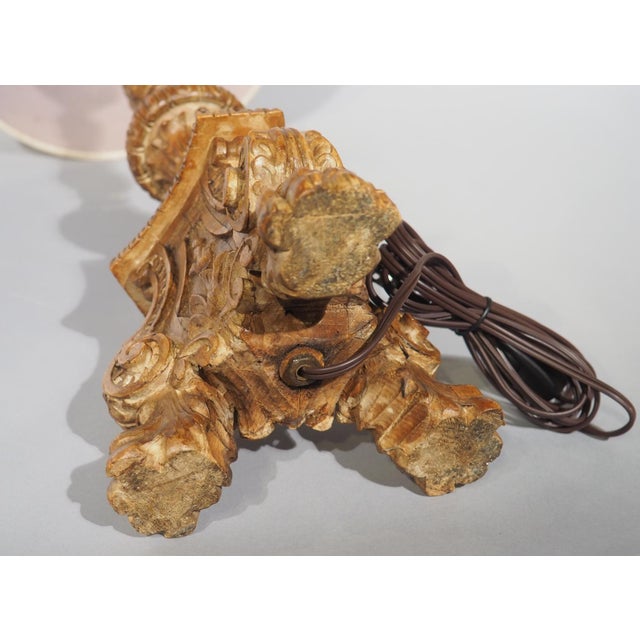 Hand-carved in the 1800s in the style of Louis XIV, this wooden candlestick has been repurposed into a wonderful table...