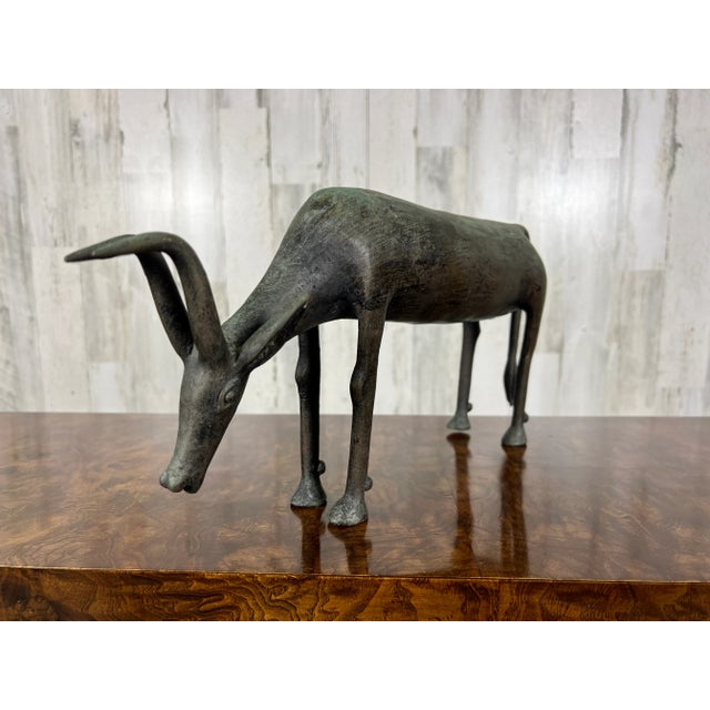 Beautiful African bronze Antelope bending its neck down to drink, in the style of the Ashanti. Great texture and detail!
