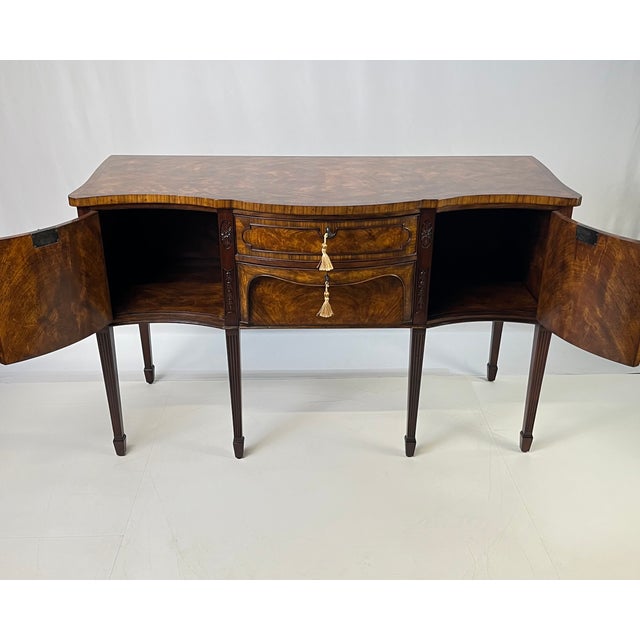 Crafted by elite furniture maker Theodore Alexander, this serpentine sideboard is an official reproduction from the...