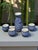 This vintage Chinese blue and white sake set includes a decanter and four cups, showcasing traditional Chinese design and...