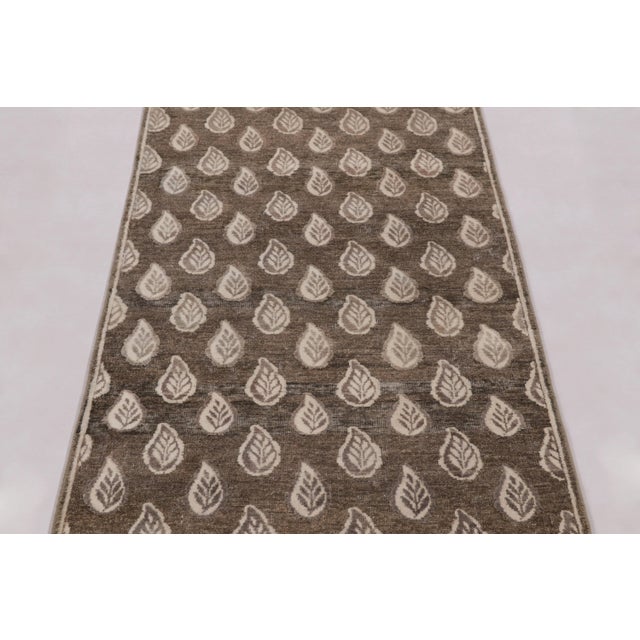 Hand-knotted in a luxurious blend of wool and silk, this 3x6 rug is a serene and sophisticated addition to the Block Print...