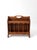 Vintage wooden magazine rack in an Early American style, featuring turned spindle sides and softly shaped panels. The warm...