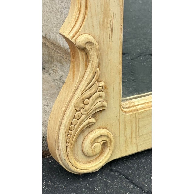 Lexington wall mirror features a bleached oak wood frame with a natural grain, designed in an ornate French Provincial or...