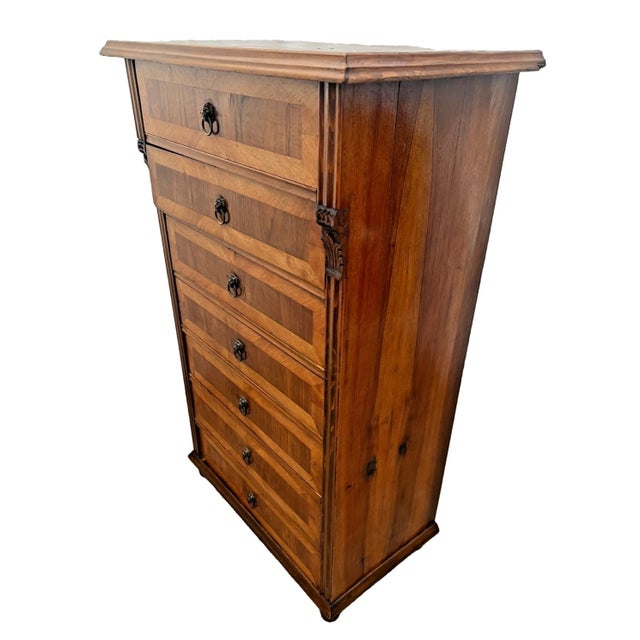 Bring European elegance and historic craftsmanship into your home with this magnificent antique tall chest of drawers,...