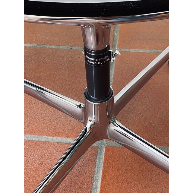 A pair of Eames Aluminium Chairs Model EA 108, designed by Charles and Ray Eames in 1958. The chairs showcase a minimalist...