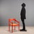 Carimate style chair with an orange lacquered wood frame, characterized by simple and functional lines reminiscent of the...