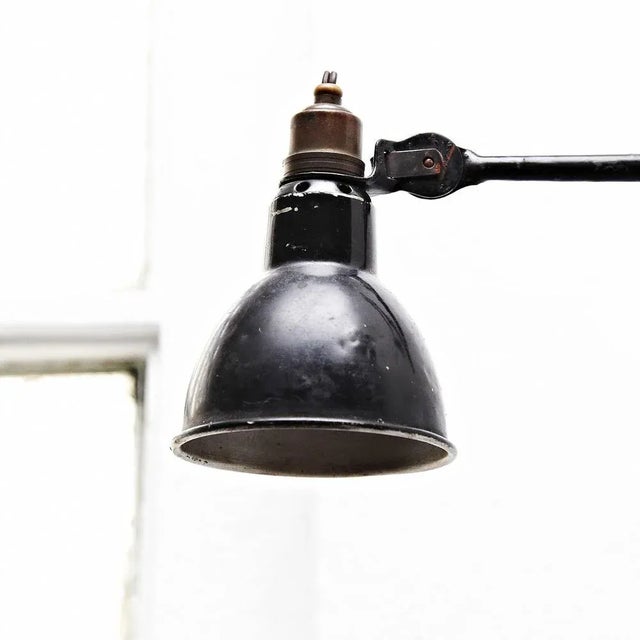 Wall lamp designed by Bernard-Albin Gras. Manufactured by Gras (France), circa 1930. Aluminium and steel. In good original...