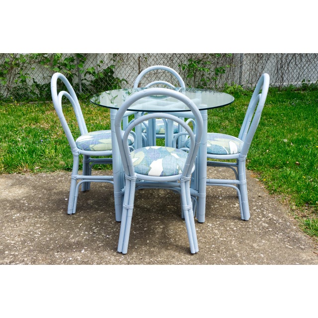 A bamboo rattan patio dining set featuring a 36" round glass-top table and four matching chairs. Beautifully refinished in...