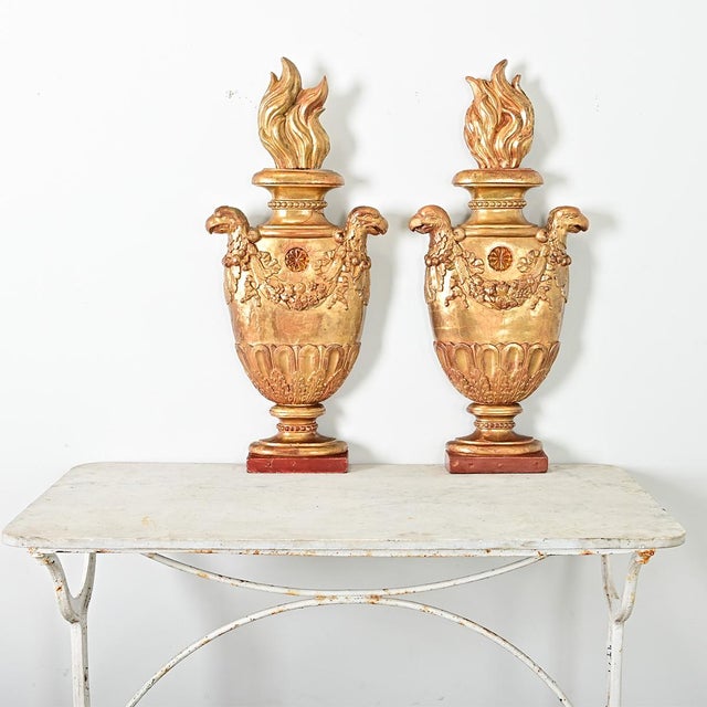 A stunning pair of Italian 19th century giltwood wall appliqués, decorative elements to enhance the architectural program...