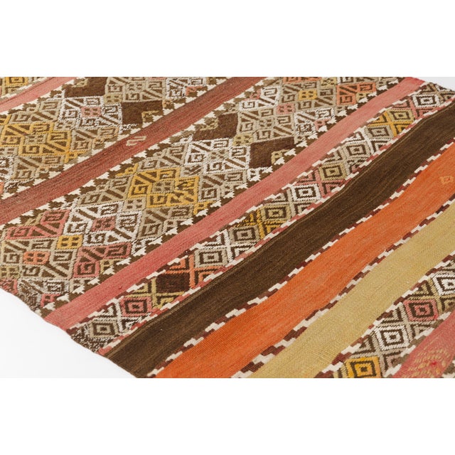 This is a vintage Turkish Oushak rug from the Mid 20th Century. The piece was hand-knotted.