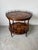 A beautifully crafted vintage Theodore Alexander two-tier accent table featuring elegant Regency styling. This round table...