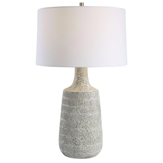 Drawing Inspiration From Antique Clay Pottery, This Table Lamp Is Handcrafted From Ceramic In A Mottled Gray And Off-white...