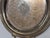 Design Plus Gallery presents a Vintage Silverplate Engraved Round Handled Tray. The circular form has a raised rim, two...