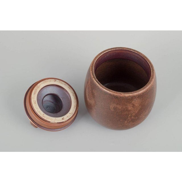 Erik Rahr for Saxbo Lidded jar, mid-20th century. Organically shaped stoneware lidded jar with a matte brown glaze in warm...
