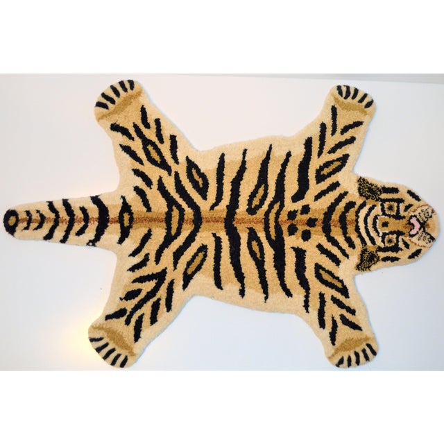 This is arug in the shape of a Tiger. It is called a Persian hunting rug and they are often done with various animal...