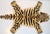 This is arug in the shape of a Tiger. It is called a Persian hunting rug and they are often done with various animal...