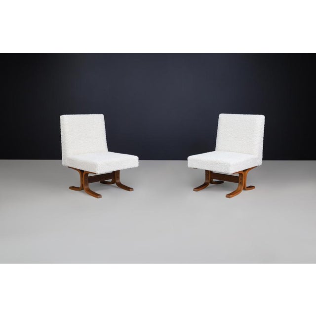 This refined set of two mid-century lounge chairs, attributed to renowned Czech designer Ludvik Volak, perfectly embodies...