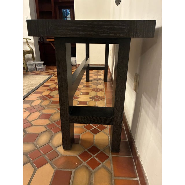 A refined Holly Hunt console table crafted in beautifully finished wood with clean, architectural lines. Minimal yet...