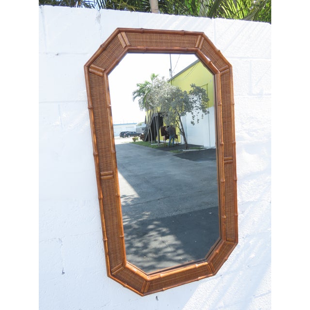 This gorgeous Pair of Mirrors is made of wood, caning, rattan, and mirror. It was made by American of Martinsville, they...