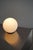 The Dioscuri table lamp, designed by Michele De Lucchi for Artemide in 1999, features a spherical diffuser in acid-etched...