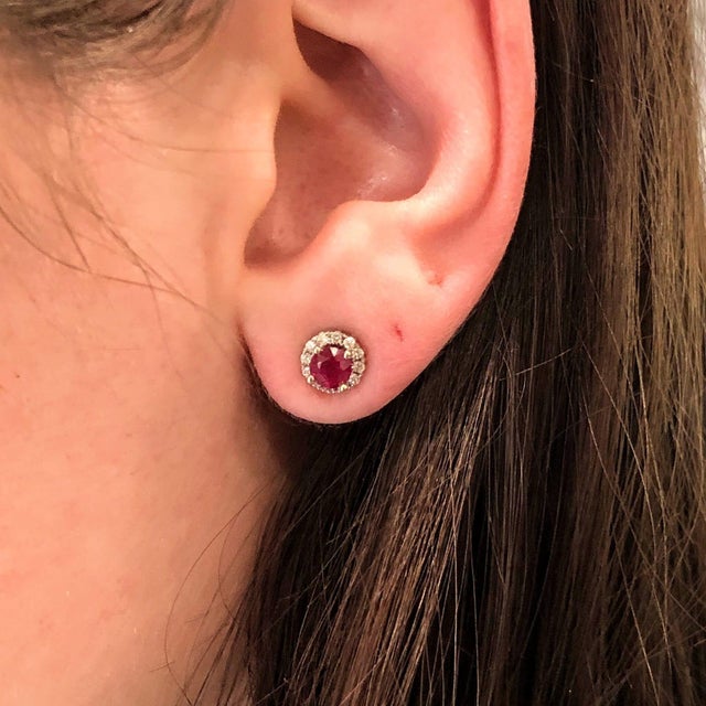 Add a little magic with these fiery crimson-red Ruby stud earrings, set in solid 14K White Gold. Each earring centers a...