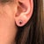 Add a little magic with these fiery crimson-red Ruby stud earrings, set in solid 14K White Gold. Each earring centers a...