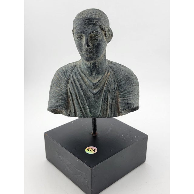 This vintage miniature sculpture depicts a charioteer from Delphi. Crafted in Greece, this licensed reproduction bust is...